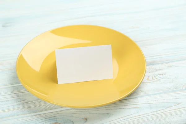 Yellow plate with card — Stock Photo, Image