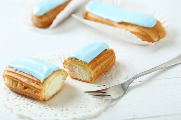 Tasty eclairs with glaze — Stock Photo, Image