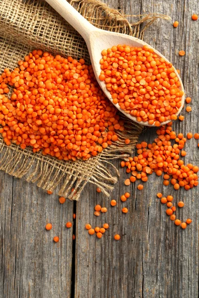 Red lentils in the wooden spoon — Stock Photo, Image