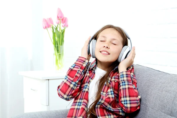 Jong meisje met koptelefoon — Stockfoto