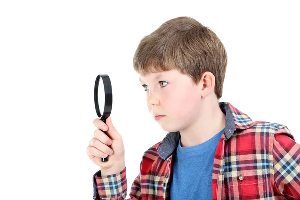 Young boy with magnifying glass — Stockfoto