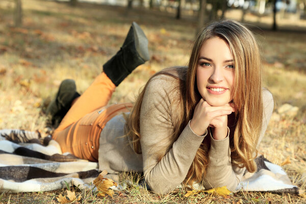 Beautiful young girl in autumn park 