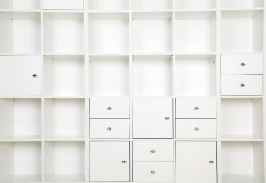 Empty shelves in white rack