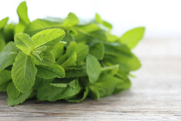 Fresh mint leaves on wooden table — Stock Photo, Image