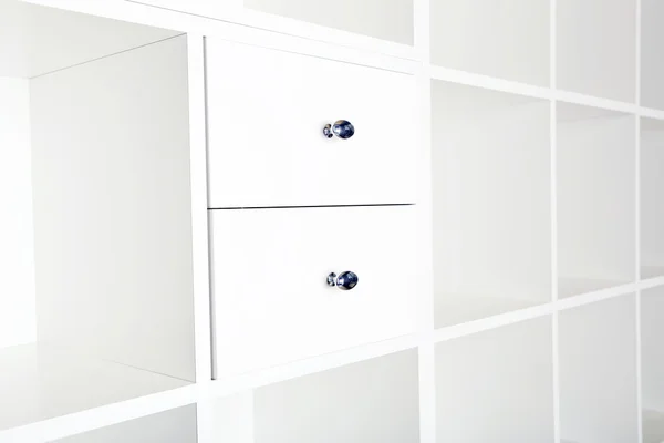 Empty shelves in white wooden rack — Stock Photo, Image