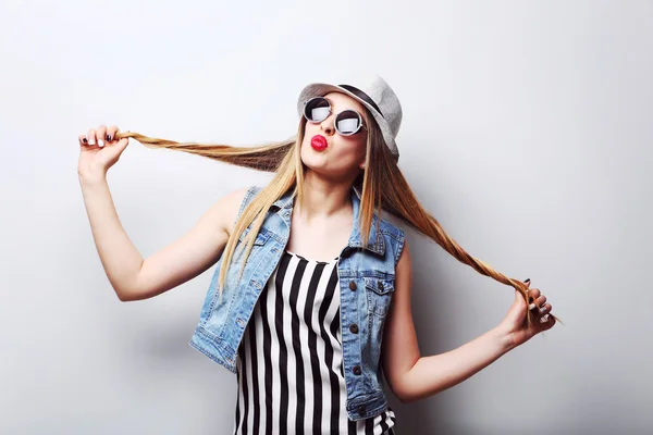 Hipster girl on grey background — Stock Photo, Image