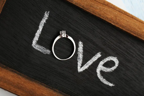 Diamond ring on wooden frame — Stock Photo, Image