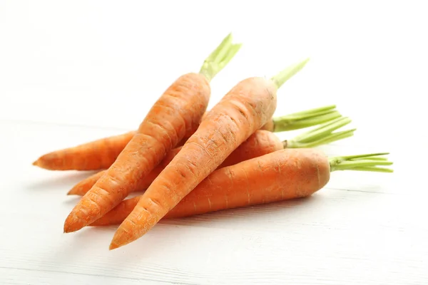 Fresh carrots on a white — Stock Photo, Image