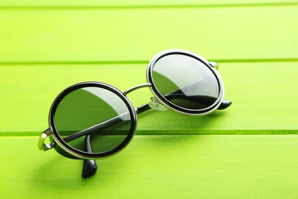 Black sunglasses on table — Stock Photo, Image