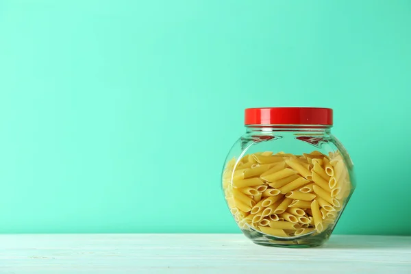 Pasta in jar on table