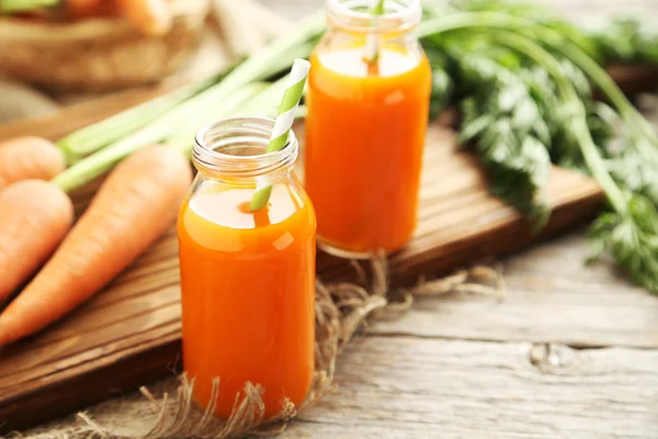 Fresh carrot juice in bottles — Stock Photo, Image