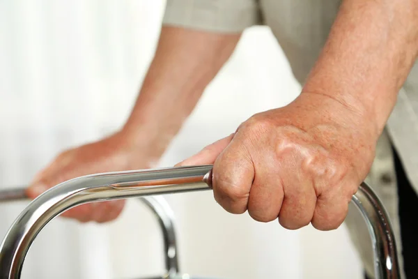 hands holding on a walker
