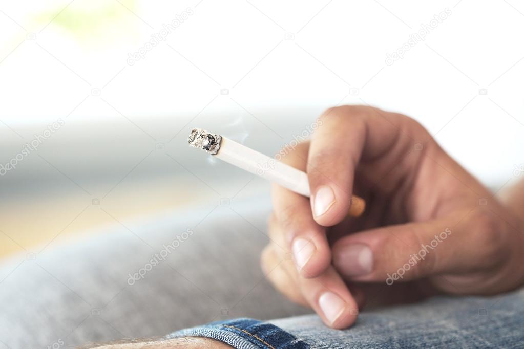 Male hand holding  cigarette