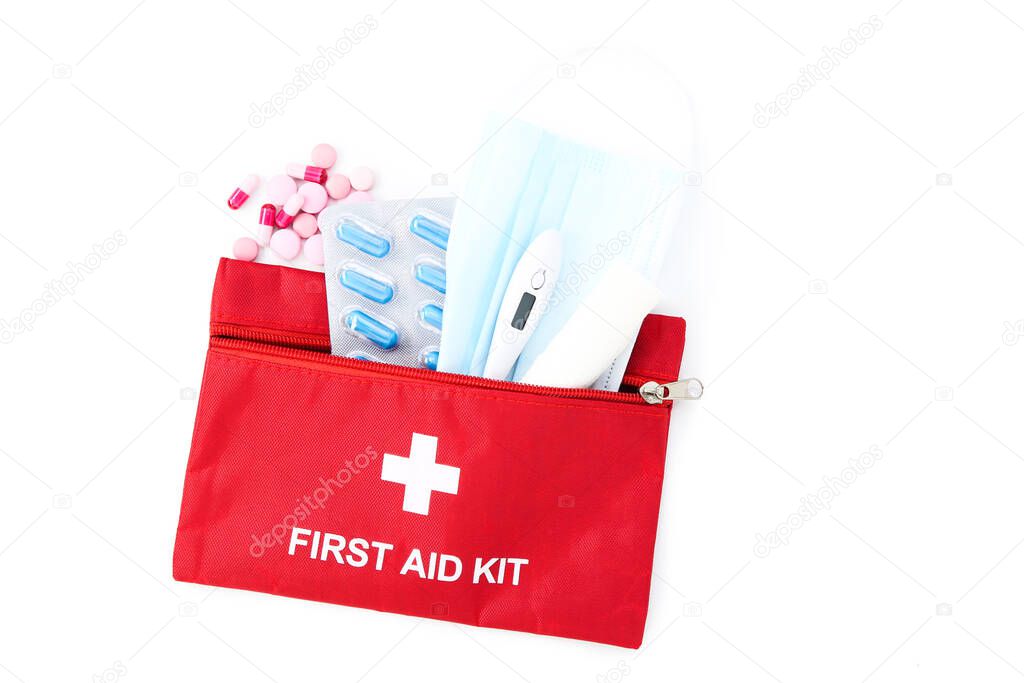 First aid kit with medical supplies isolated on white background