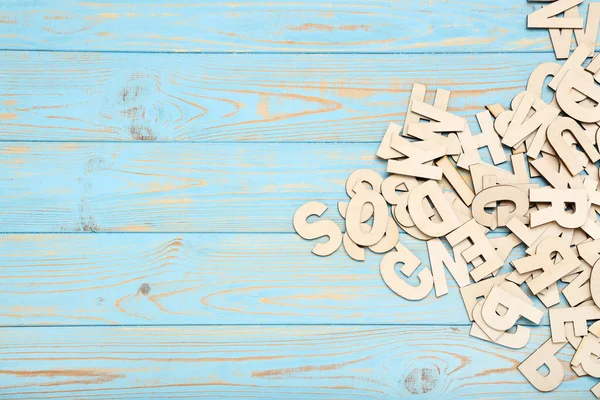 Wooden letters on blue table