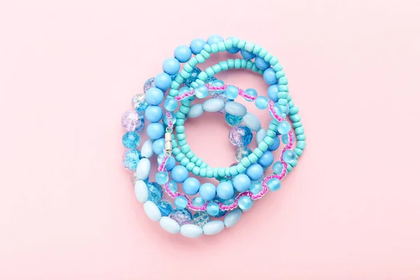 Beautiful Blue Bracelets Pink Background — Stock Photo, Image