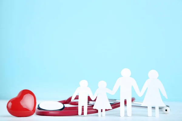 Family Figures Red Heart Stethoscope Blue Background — Stock Photo, Image