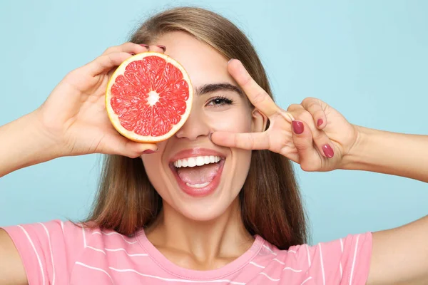 Ung Flicka Med Färsk Grapefrukt Blå Bakgrund — Stockfoto