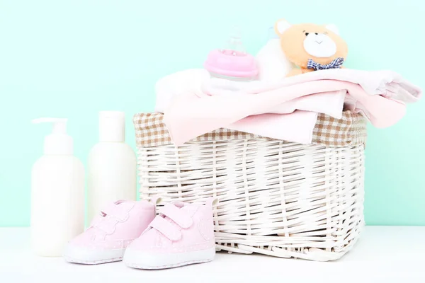 带有瓶子和蓝色背景的软熊玩具的婴儿衣服 — 图库照片