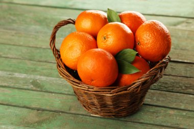 Ripe mandarins in basket clipart