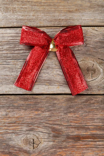 Red bow on wooden background — Stock Photo, Image