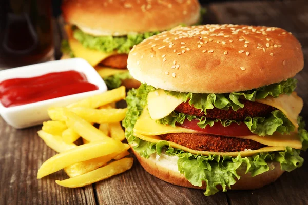 Big burger on wooden background — Stock Photo, Image