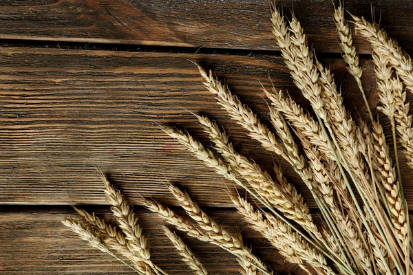 Wheat ears on wooden background — Stock Photo, Image