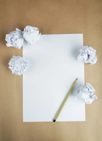 Crumpled up papers with sheet and pencil — Stock Photo, Image