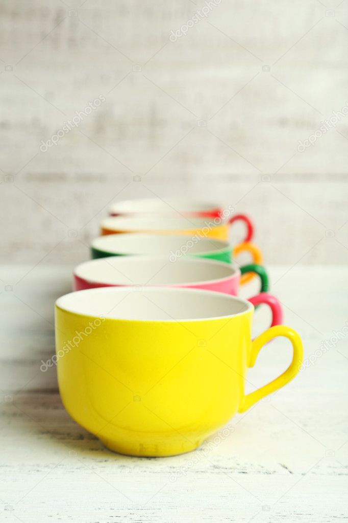 Colorful cups on white background