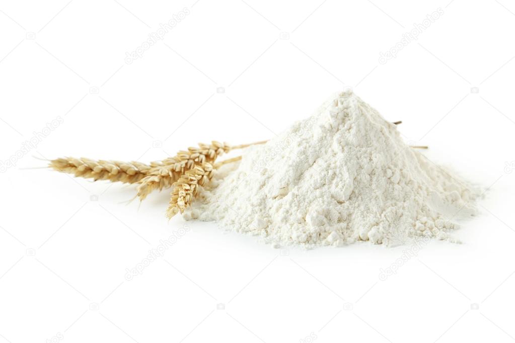 Heap of wheat flour with spikelets