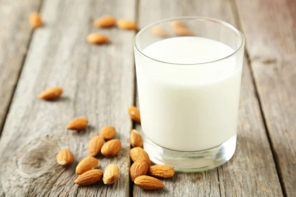 Glass of milk with almonds — Stock Photo, Image