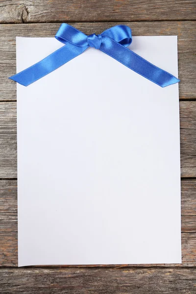 Czysty papier arkusz z kokarda niebieski — Zdjęcie stockowe