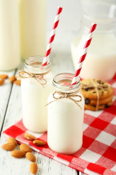 Botellas de leche con pajitas y galletas a rayas — Foto de Stock