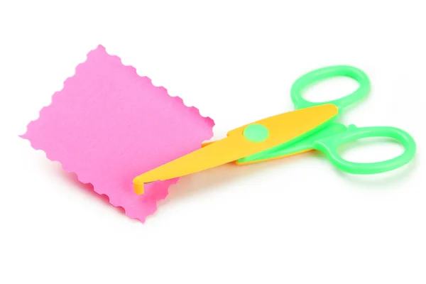 Figured scissors cutting pink paper — Stock Photo, Image