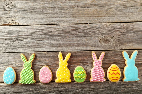 Colorful easter cookies on grey wooden background — Stock Photo, Image