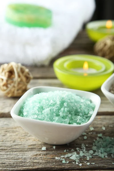 Sea salt in white bowl with candles — Stock Photo, Image