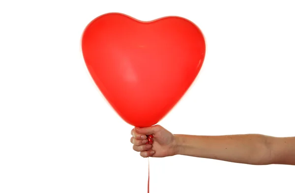 Mano sosteniendo un globo rojo del corazón — Foto de Stock