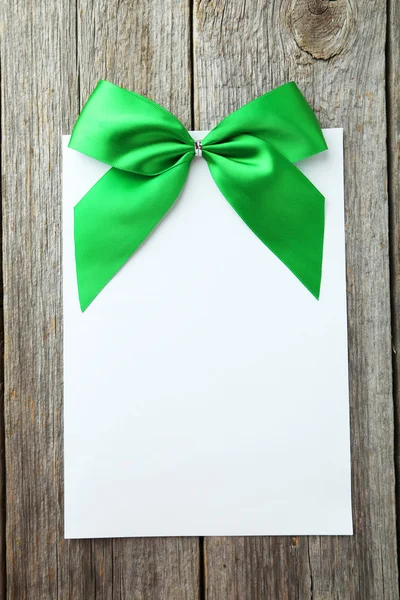 Foglio di carta bianca con fiocco verde — Foto Stock