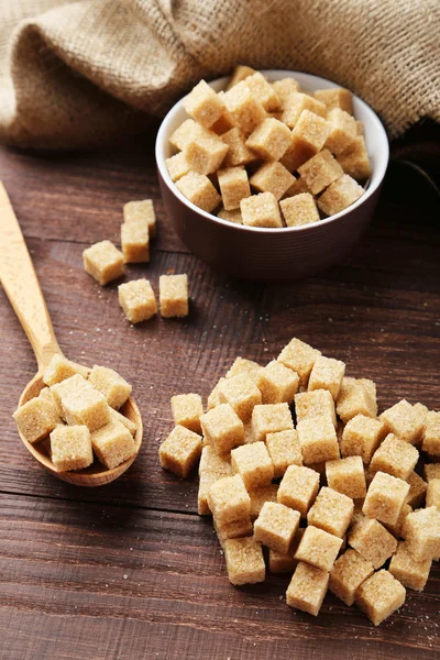 Brown sugar in spoon and bowl