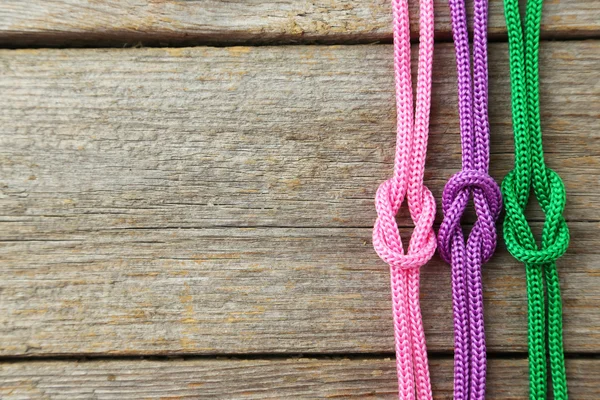 Colorful ropes on wooden background — Stock Photo, Image