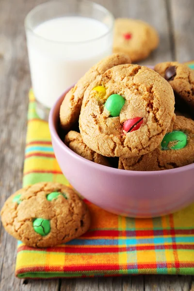 Colorful candies and glass of milk — Stock Photo, Image