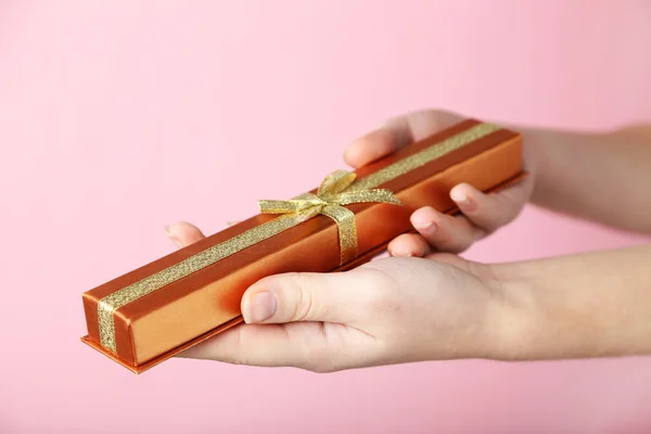 Female hands holding gift box — Stock Photo, Image