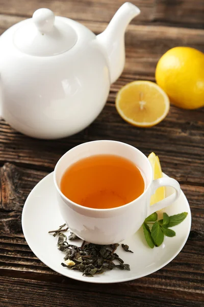 Cup with green tea and teapot — Stock Photo, Image