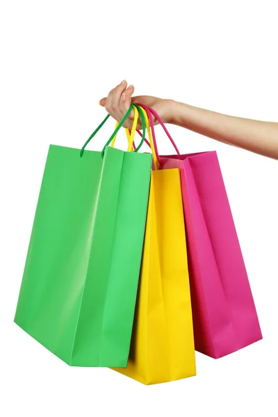 Mão segurando sacos de compras coloridos — Fotografia de Stock
