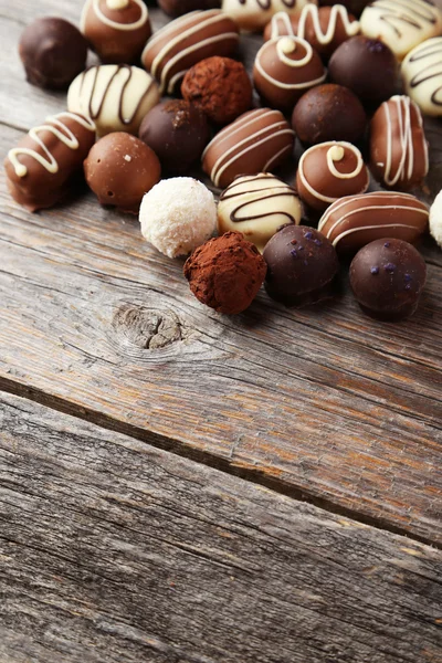 Chocolates on wooden background — Stock Photo, Image