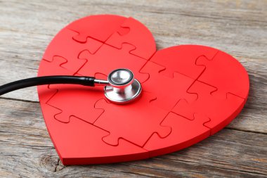 Red puzzle heart with stethoscope clipart