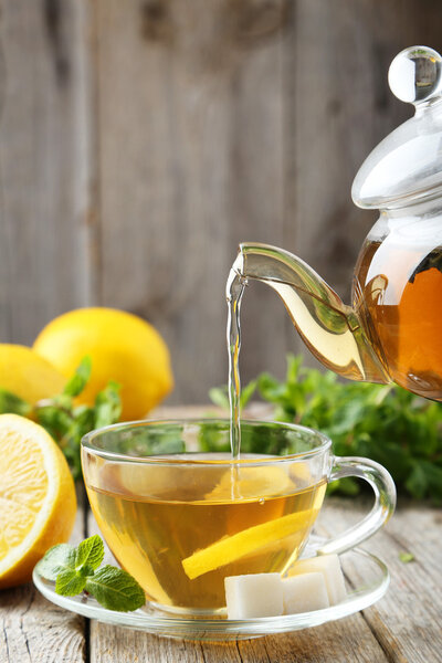 Pouring tea into cup of tea