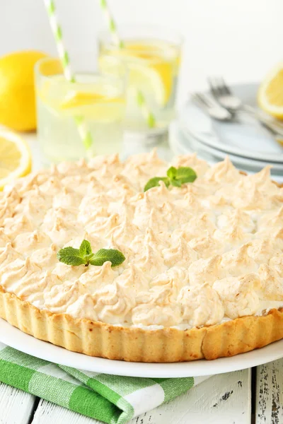 Lemon meringue pie on plate on white wooden background — Stock Photo, Image