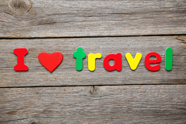 I love travel words made of colorful magnets on wooden background