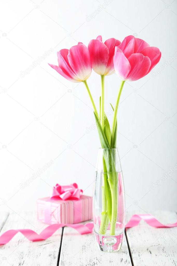 Beautiful tulips in vase  with present